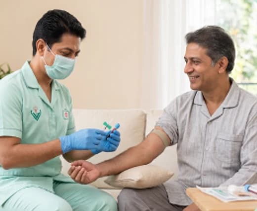 Phlebotomist collecting a blood sample from a patient at home